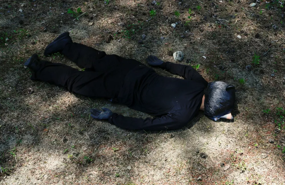 A man wearing a bear costume plays dead after a simulated hunt during an emergency drill for a bear intrusion in Yaita, Tochigi Prefecture, Japan, June 17, 2026. REUTERS/Kim Kyung-Hoon