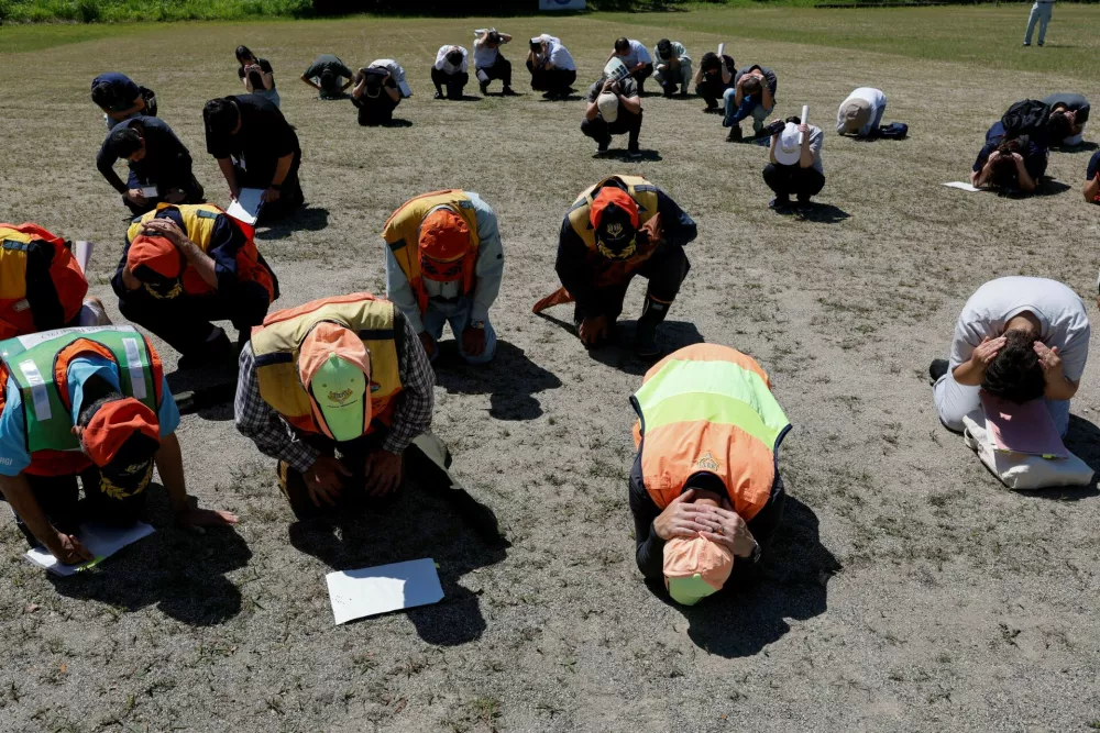 Participants take part in an earthquake drill ahead of an emergency response drill for a simulated bear intrusion in Yaita, Tochigi Prefecture, Japan, June 17, 2026. REUTERS/Kim Kyung-Hoon
