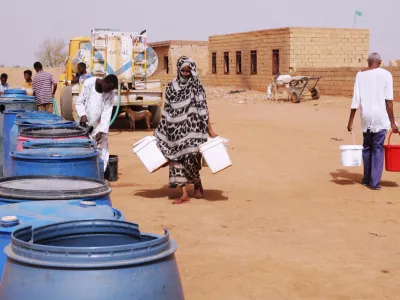 FILE - People fill water containers at a free distribution point amid water outages in Khartoum, Sudan, May 18, 2026. (AP Photo/Marwan Ali, File)
