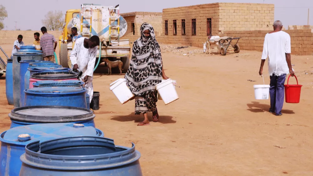FILE - People fill water containers at a free distribution point amid water outages in Khartoum, Sudan, May 18, 2026. (AP Photo/Marwan Ali, File)