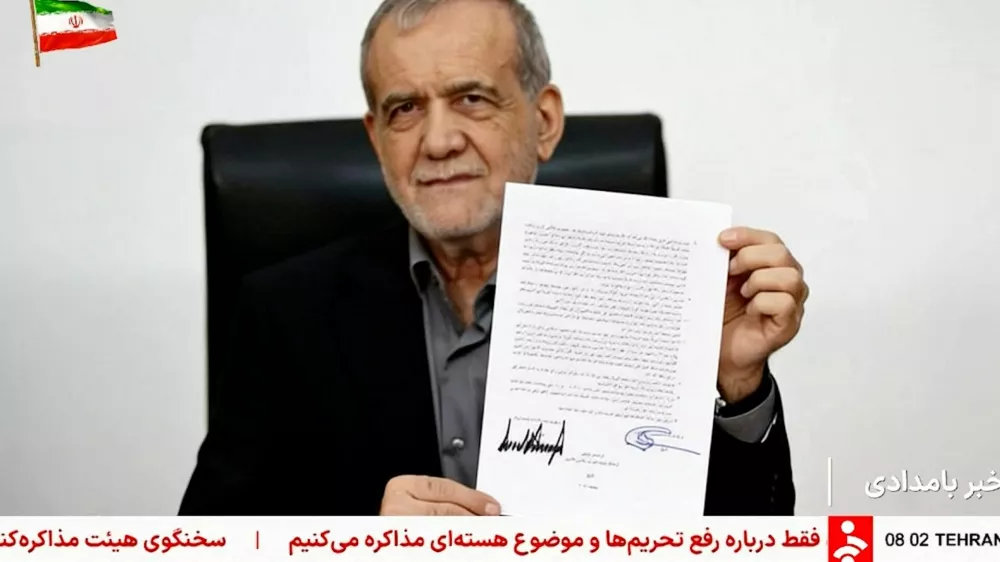 A screen grab shows Iran's President Masoud Pezeshkian holding a memorandum signed with U.S. President Donald Trump in Tehran, Iran, June 18, 2026, taken from a video. Pool via WANA/Reuters TV/Handout via REUTERS  THIS IMAGE HAS BEEN SUPPLIED BY A THIRD PARTY. ISRAEL OUT. NO COMMERCIAL OR EDITORIAL SALES IN ISRAEL. NO USE BBC PERSIAN. NO USE VOA PERSIAN. NO USE MANOTO. NO USE IRAN INTERNATIONAL. NO USE RADIO FARDA, NO USE ISRAEL. FOR REUTERS CUSTOMERS ONLY. OVERLAYS FROM SOURCE.