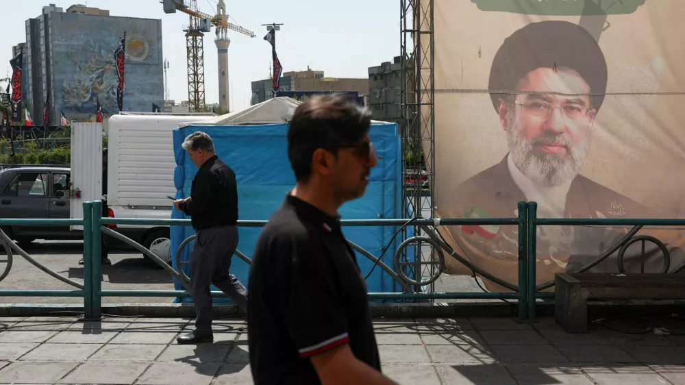 People walk past a banner with a picture of Iran's Supreme Leader, Mojtaba Khamenei, in Tehran, Iran, June 17, 2026. Majid Asgaripour/WANA (West Asia News Agency) via REUTERS ATTENTION EDITORS - THIS PICTURE WAS PROVIDED BY A THIRD PARTY.   ATTENTION EDITORS - THIS PICTURE WAS PROVIDED BY A THIRD PARTY. ISRAEL OUT. NO COMMERCIAL OR EDITORIAL SALES IN ISRAEL. NO ACCESS FOR ISRAELI MEDIA. NO USE BBC PERSIAN. NO USE VOA PERSIAN. NO USE MANOTO. NO USE IRAN INTERNATIONAL. NO USE RADIO FARDA. DIGITAL: NO USE BBC PERSIAN. NO USE VOA PERSIAN. NO USE MANOTO. NO USE IRAN INTERNATIONAL. NO USE RADIO FARDA.