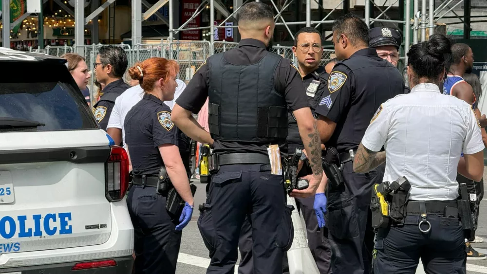 New York Police Department officers gather after alleged gunfire was heard in Times Square, in New York City, U.S., June 18, 2026. Picture taken with a phone. REUTERS/Andrew Hofstetter