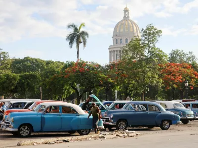 A man walks near a vintage taxi before the Cuban government presents far-reaching economic measures that could mark the most significant shift toward a market economy since the 1959 revolution, in Havana, Cuba June 17, 2026. REUTERS/Norlys Pere