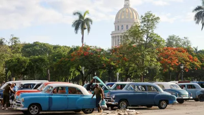 A man walks near a vintage taxi before the Cuban government presents far-reaching economic measures that could mark the most significant shift toward a market economy since the 1959 revolution, in Havana, Cuba June 17, 2026. REUTERS/Norlys Pere