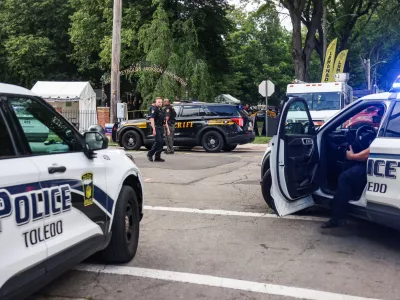 Toledo police investigates a shooting that left 12 people injured at the Old West End Festival at the Agnes Reynolds Jackson Arboretum in Toledo, Ohio on Saturday, June 6, 2026. (Rebecca Benson/The Blade via AP)