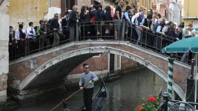 VENICE, ITALY - MAY 18, 2012: Tourists in the crowded the bridge in Venice.