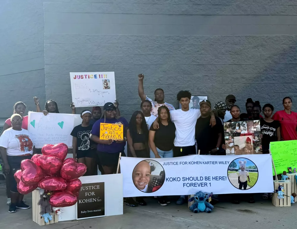 In this photo provided by Marquell Bridges, a group of mourners attend a makeshift memorial for 1-year old Kohen Wiley, outside the Walmart where the boy was shot by police in Senatobia, Miss., on Wednesday, June 17, 2026. (Courtesy Marquell Bridges via AP)