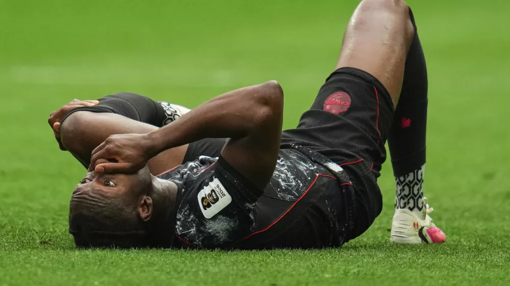 Canada's Ismael Kone reacts on the ground after sustaining an injury during the World Cup Group B soccer match against Qatar in Vancouver, British Columbia, Thursday, June 18, 2026. (AP Photo/Abbie Parr)