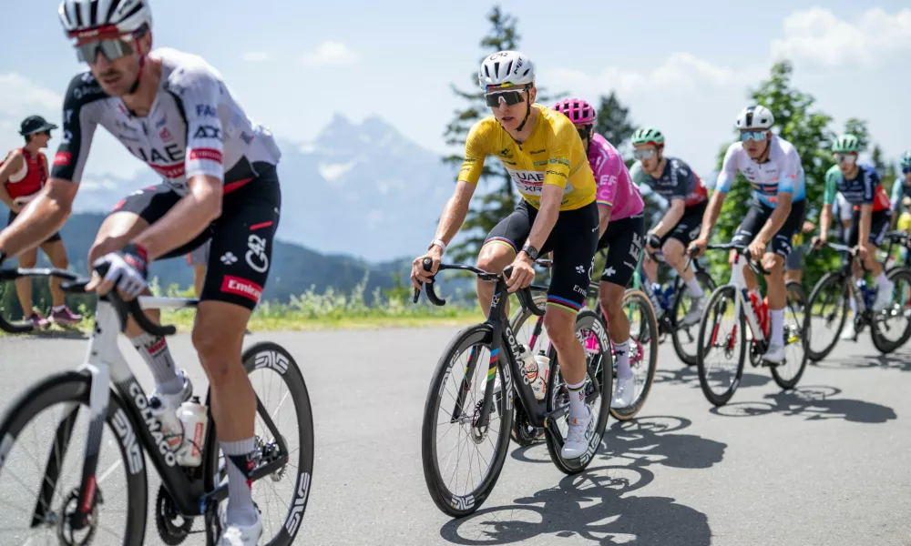 Tadej Pogacar, center, from Slovenia of UAE Team Emirates-XRG competes during the fifth and final stage, a 151 km race with start and finish in Villars-sur-Ollon, Switzerland, at the 89th Tour de Suisse UCI World Tour cycling race, on Sunday, June 21, 2026. (Gian Ehrenzeller/Keystone via AP)