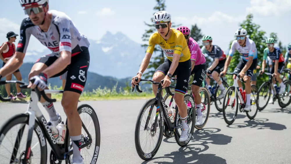 Tadej Pogacar, center, from Slovenia of UAE Team Emirates-XRG competes during the fifth and final stage, a 151 km race with start and finish in Villars-sur-Ollon, Switzerland, at the 89th Tour de Suisse UCI World Tour cycling race, on Sunday, June 21, 2026. (Gian Ehrenzeller/Keystone via AP)