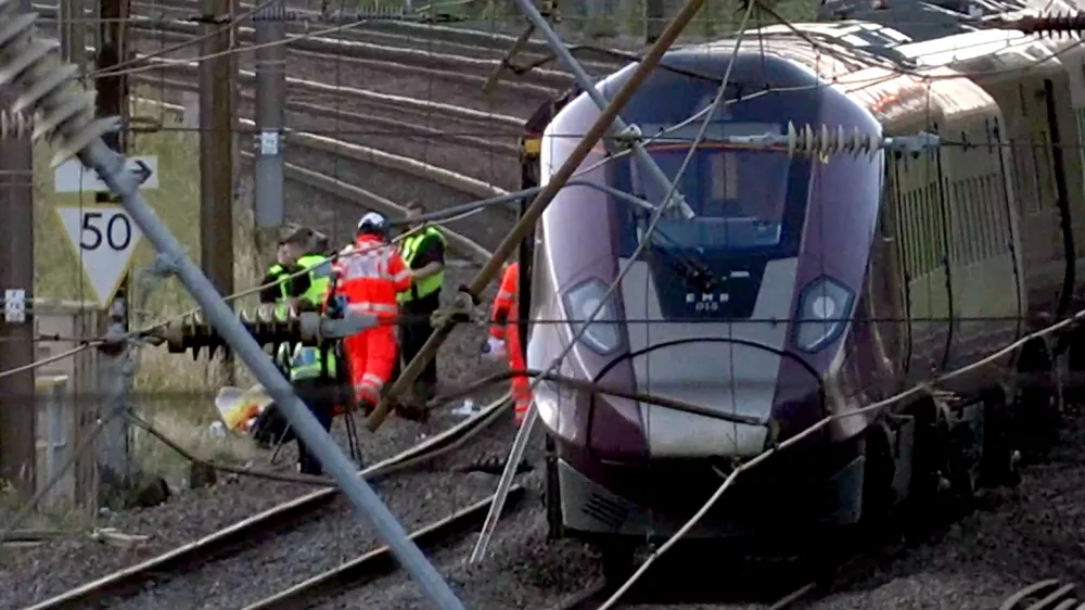 Emergency personnel work on a train on the tracks outside Bedford, England, after a train from Corby to London St. Pancras and another from Nottingham to London St. Pancras, collided on Friday June 19, 2026. (Jamie Lashmar/PA via AP)