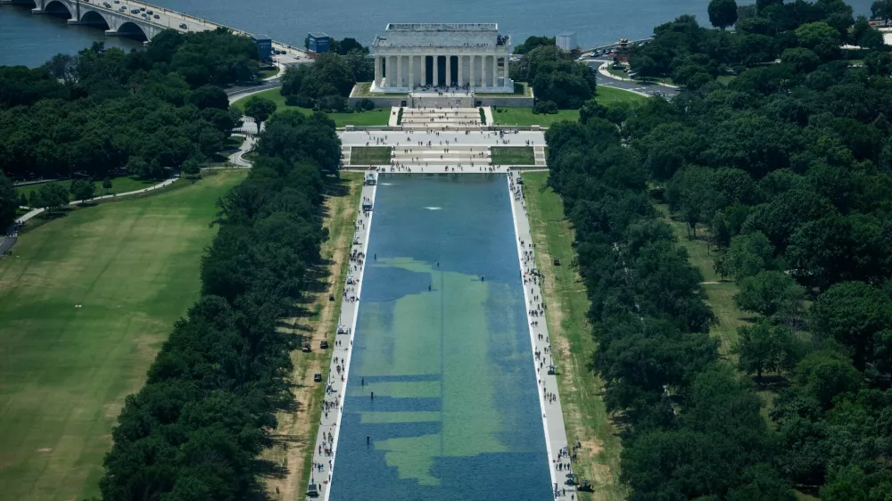In an aerial view from the Washington Monument, crews remove algae from the bottom of the Lincoln Memorial Reflecting Pool after recent renovations following a directive from U.S. President Donald Trump to paint it blue ahead of the 250th anniversary of U.S. independence, in Washington, D.C., U.S., June 19, 2026. REUTERS/Aaron Schwartz
