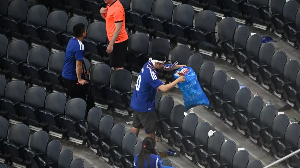 Japan fans clean up trash in the stadium following the World Cup Group F soccer match between the Netherlands and Japan in Arlington, Texas, near Dallas, Sunday, June 14, 2026. (AP Photo/Jessica Tobias)