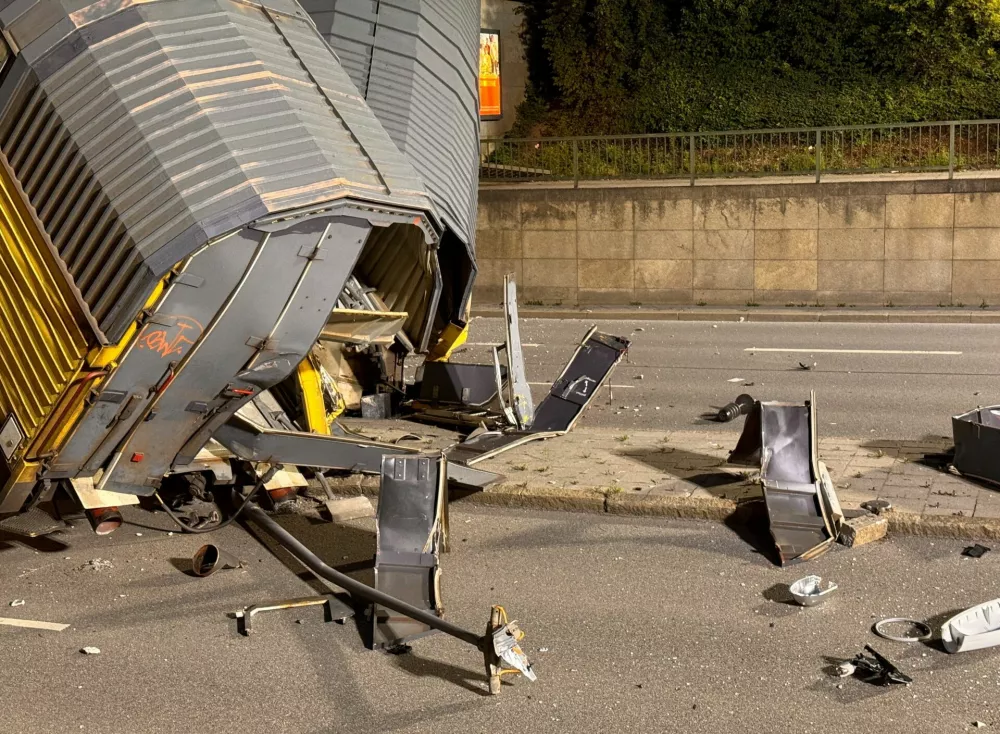 Two cars of a freight train which derailed after a collision, fell off a bridge and lay on a road in Munich, Germany, June 20, 2026.  REUTERS/Christine Uyanik