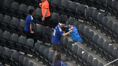 Japan fans clean up trash in the stadium following the World Cup Group F soccer match between the Netherlands and Japan in Arlington, Texas, near Dallas, Sunday, June 14, 2026. (AP Photo/Jessica Tobias)