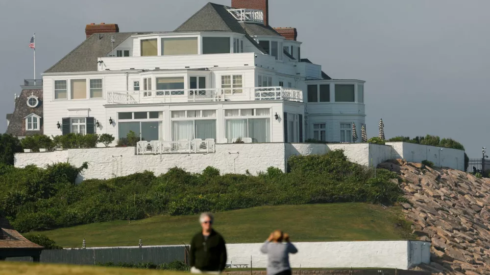 Visitors walk the lawn at Watch Hill Lighthouse and look towards the home of singer and songwriter Taylor Swift in the Watch Hill neighborhood in Westerly, Rhode Island, U.S., June 18, 2026. REUTERS/CJ Gunther