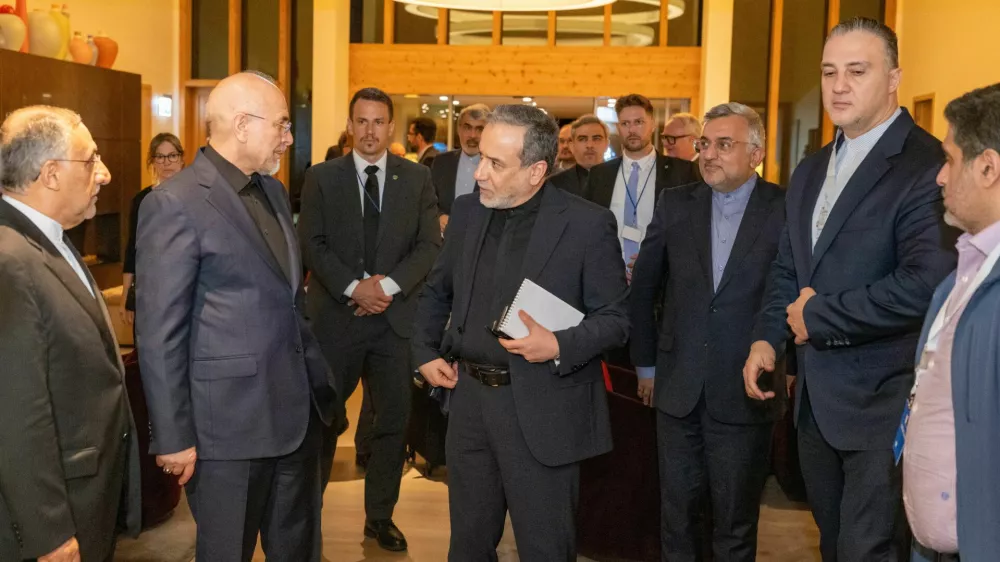 Iranian Foreign Minister Seyyed Abbas Araghchi, center, and Speaker of the Islamic Parliament of Iran Mohammed Bagher Ghalibaf, left, arrive at the Buergenstock resort in Obbuergen, near Lucerne, Switzerland, early Sunday, June 21, 2026. (Urs Flueeler/Keystone, Pool via AP)