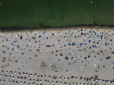 People visit the beach of the Baltic Sea during hot weather in Travemuende, Germany, Saturday, June 20, 2026. (AP Photo/Michael Probst)