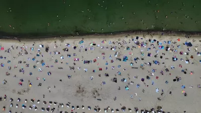 People visit the beach of the Baltic Sea during hot weather in Travemuende, Germany, Saturday, June 20, 2026. (AP Photo/Michael Probst)
