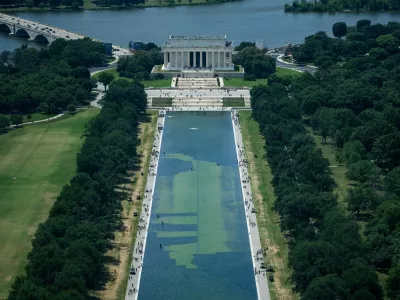 In an aerial view from the Washington Monument, crews remove algae from the bottom of the Lincoln Memorial Reflecting Pool after recent renovations following a directive from U.S. President Donald Trump to paint it blue ahead of the 250th anniversary of U.S. independence, in Washington, D.C., U.S., June 19, 2026. REUTERS/Aaron Schwartz