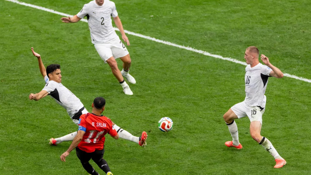 Egypt's Mohamed Salah (10) strikes the ball between New Zealand's defenders during the second half of a World Cup Group G soccer match, in Vancouver, British Columbia, Sunday, June 21, 2026. (Timothy Matwey/The Canadian Press via AP)