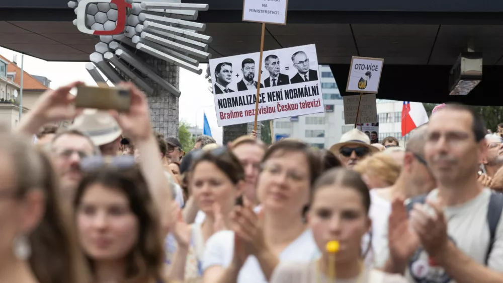 People display a sign reading "Normalization is not normal, let's defend Czech television" during a protest rally in support of public media as the Czech government plans to revamp and cut funding for Czech TV and Czech Radio, in Prague, Czech Republic, June 21, 2026 REUTERS/Eva Korinkova