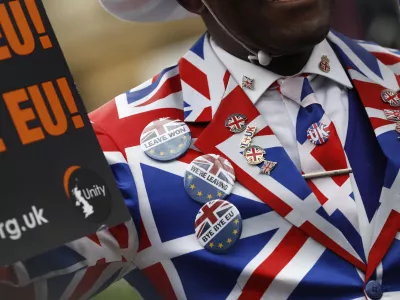 FILE - A Brexit supporter demonstrates in Parliament Square in London, Friday, Jan. 31, 2020. (AP Photo/Alastair Grant, File)