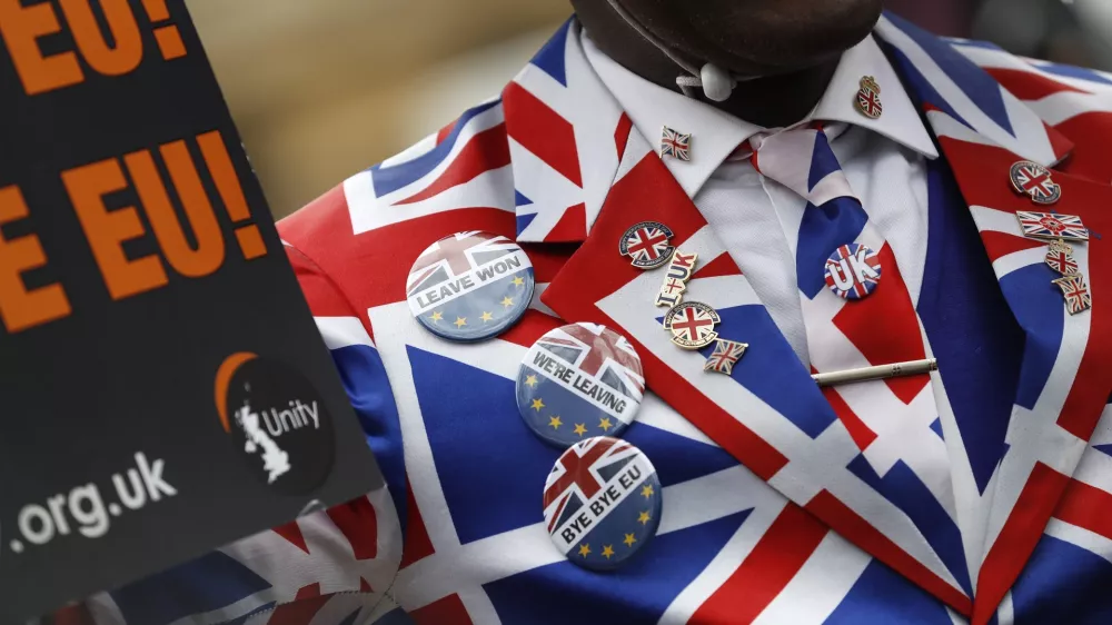 FILE - A Brexit supporter demonstrates in Parliament Square in London, Friday, Jan. 31, 2020. (AP Photo/Alastair Grant, File)