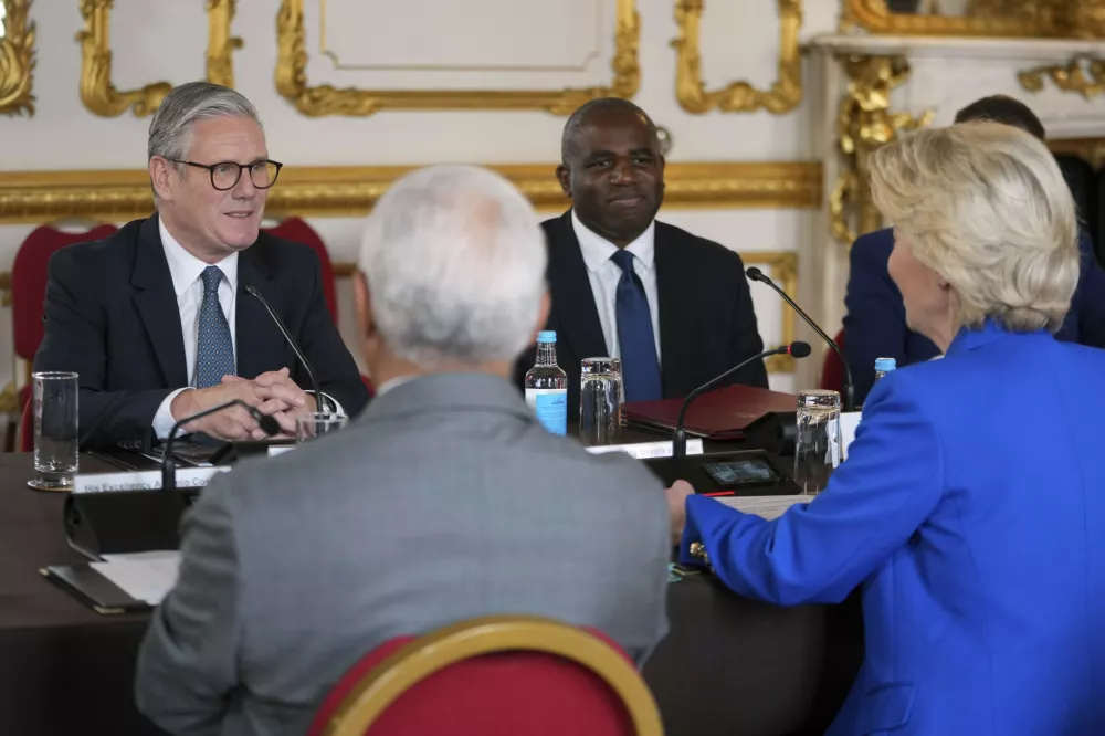 Britain's Prime Minister Keir Starmer and Foreign Secretary David Lammy listen to European Commission President Ursula von der Leyen, right, and European Council President Antonio Costa, left, during a meeting between the U.K. and the European Union to discuss closer ties in their first official summit since Brexit, in London, Monday, May 19, 2025.(AP Photo/Kin Cheung, Pool)