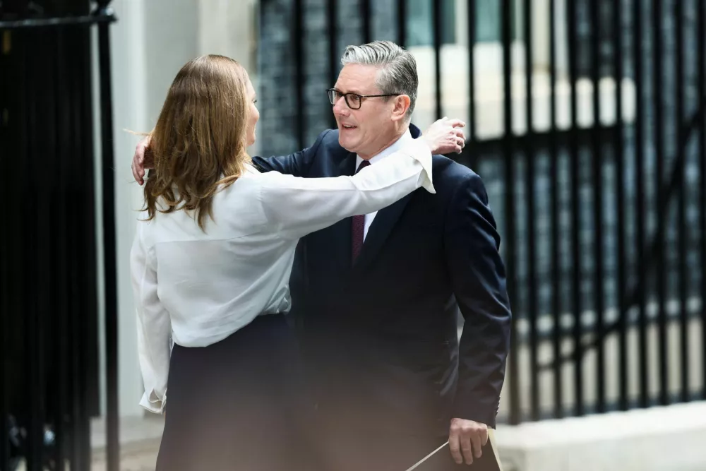 British Prime Minister Keir Starmer goes to embrace his wife Victoria, as he announces the timeline for his resignation, outside 10 Downing Street, in London, Britain, June 22, 2026. REUTERS/Toby Shepheard