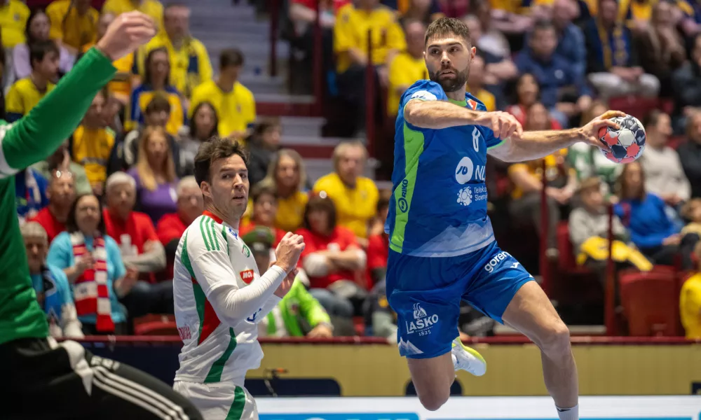 Slovenia's Blaž Janc, right, in action during the 2026 EHF European Men's Handball Championship main round match between Slovenia and Hungary at Malmo Arena, in Malmo, Sweden, Sunday, Jan. 25, 2026. (Johan Nilsson/TT via AP)