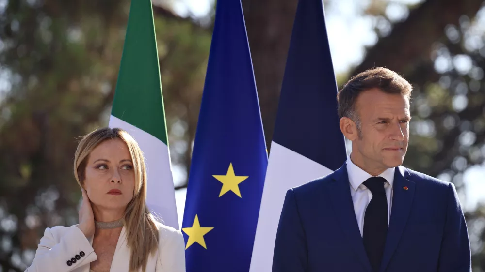 Italian Prime Minister Giorgia Meloni, left, attends a joint press conference with French President Emmanuel Macron, right, as part of a Franco-Italian summit in Antibes, southern France, Thursday, June 25, 2026. (Manon Cruz/Pool Photo via AP)