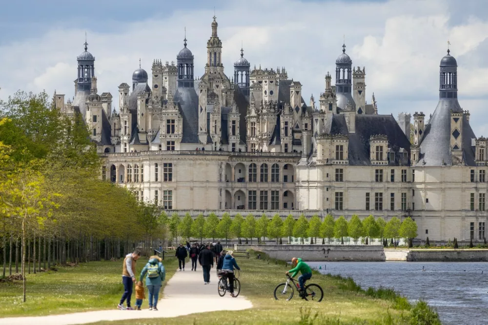 ORLEANS, April 30, 2024 -- Tourists visit the Chambord Castle in Loire Valley, France, April 28, 2024. The chateaux of the Loire Valley are part of the architectural heritage of the historic towns of Amboise, Angers, Blois, Chinon, Montsoreau, Orleans, Saumur, and Tours along the river Loire in France. They illustrate Renaissance ideals of design in France.,Image: 869066940, License: Rights-managed, Restrictions:, Model Release: no 