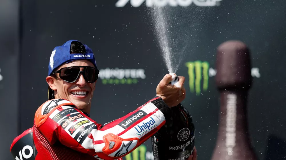 FILE PHOTO: MotoGP - Czech Republic Grand Prix - Masaryk Circuit, Brno, Czech Republic - June 21, 2026 Ducati Lenovo Team's Marc Marquez sprays champagne out of the bottle after winning the race REUTERS/David W Cerny/File Photo