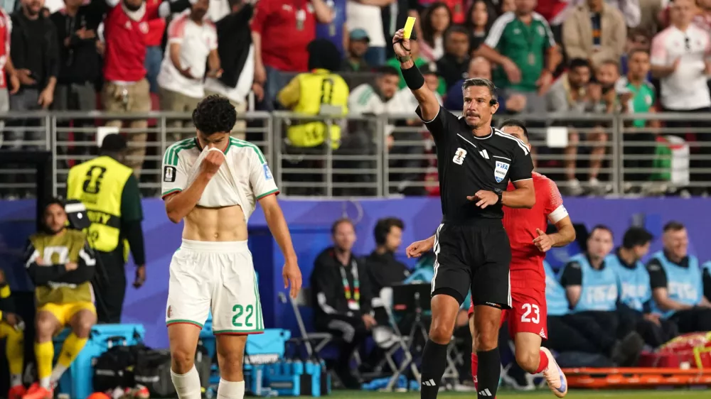 Soccer Football - FIFA World Cup 2026 - Group J - Jordan v Algeria - San Francisco Bay Area Stadium, Santa Clara, California, U.S. - June 22, 2026 Referee Slavko Vincic shows a yellow card to Algeria's Ramiz Zerrouki IMAGN IMAGES via Reuters/David Gonzales