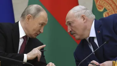 Russian President Vladimir Putin and Belarusian President Alexander Lukashenko talk during a signing ceremony following a meeting of the Supreme State Council of the Russia-Belarus Union State marking the 25th anniversary of the Union State Treaty in Minsk, Belarus, Friday, Dec. 6, 2024.(Gavriil Grigorov, Sputnik, Kremlin Pool Photo via AP)