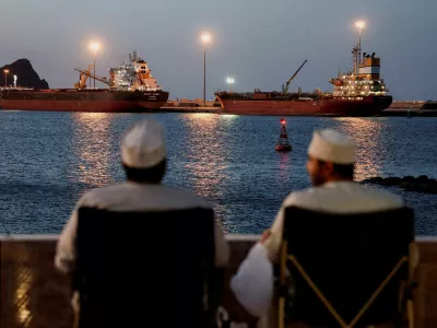 FILE PHOTO: The Galaxy Globe bulk carrier and the Luojiashan tanker sit anchored as Iran vows to close the Strait of Hormuz, amid the U.S.-Israeli conflict with Iran, in Muscat, Oman, March 9, 2026. REUTERS/Benoit Tessier/File Photo