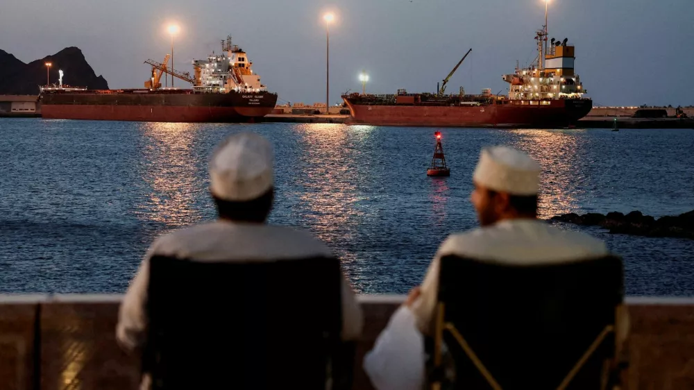 FILE PHOTO: The Galaxy Globe bulk carrier and the Luojiashan tanker sit anchored as Iran vows to close the Strait of Hormuz, amid the U.S.-Israeli conflict with Iran, in Muscat, Oman, March 9, 2026. REUTERS/Benoit Tessier/File Photo