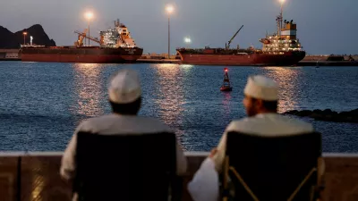 FILE PHOTO: The Galaxy Globe bulk carrier and the Luojiashan tanker sit anchored as Iran vows to close the Strait of Hormuz, amid the U.S.-Israeli conflict with Iran, in Muscat, Oman, March 9, 2026. REUTERS/Benoit Tessier/File Photo