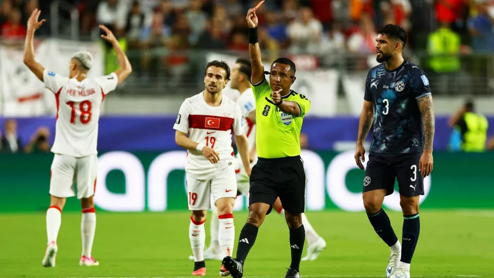 FILE PHOTO: Soccer Football - FIFA World Cup 2026 - Group D - Turkey v Paraguay - San Francisco Bay Area Stadium, Santa Clara, California, U.S. - June 19, 2026 Referee Ivan Barton shows a red card to Paraguay's Miguel Almiron REUTERS/Carlos Barria/File Photo