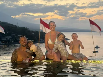 Story from Jam Press (No Doors Villa)Pictured: Lucy with her family.VIDEO: 'We had a cushty life in the UK but left FOREVER to raise our kids in Bali &ndash; our house has no windows or doors but it's paradise'A family has left the UK for good to raise their children in Bali &ndash; where they live in a home with no windows or doors.Lucy Argent had a "nice life" in the UK, with a "beautiful" home, good careers and no financial woes.But the 41-year-old and husband Paul, 36, felt stuck in the same routine, and wanted more for their three children &ndash; seven-year-old Amaya, six-year-old Roo and four-year-old Lela.They decided to convert their Cambridgeshire home into an Airbnb to rent out, generating income for them, while they fled to the Indonesian island for a complete lifestyle overhaul.Now, they say life is so sweet that they can't seem themselves ever returning to their home country &ndash; even if it means sacrificing&hellip;walls."We won't ever live in the UK again," Lucy, who owned beauty salons prior to the move, while Paul worked as a builder, told creatorzine.com."We had a nice life in the UK &ndash; a beautiful house, great careers, we made good money and had achieved everything."But we felt like we weren't living."I had my third baby and thought 'How can this be my life for the next 30 years?'"There had to be more to life than just surviving."Now, we are outside all the time, the TV is barely on and we're a lot more active because of the weather."It's a fraction of the cost to live here, and we don't have to work a 9-5."The children are thriving in this environment."Lucy, who moved to Bali two years ago, has been documenting their new lives on TikTok, where she has amassed over 100,000 followers.A recent post went viral with over half a million views, where she gave an insight into their unusual home, which is largely open to the outdoors.She said: "The villa that we live in has no windows or doors."They're kind of overrated here, really."We have these little roller blinds that come down, so when it rains heavily the inside is protected from the elements."But we've gotten used to having no windows or doors."Outside, they have a swimming pool and garden, with the villa wrapping around the space.Much of it has no windows or doors &ndash; with their living room almost totally outside, overlooking the pool.Lucy added: "It's very nice &ndash; it's a social villa and we love that it's all open plan."Despite being largely open, the home has air conditioning and fans to keep things cool, and they use incense to keep the mosquitos at bay.Meanwhile their bedroom has a tall, traditional ceiling with Lucy jokes is likely home to "a few animals", and their bathroom is outdoors, too &ndash; though still private.Lucy said: "It was very, very strange for us when we first arrived in Bali."But we've lived here for over a year now, and this is pretty normal."And when we move on &ndash; if we are ever lucky enough to build our own villa &ndash; we would design it like this, with the outdoor space and open-plan, open living, no windows and doors situation."We thought we would want something modern and aesthetic, but since living here we would absolutely more go down the traditional route &ndash; it's so perfect for families."ENDSEDITOR'S NOTE: Non-Exclusive Licence: A non-exclusive licence has been obtained directly from the verified copyright holder. The copyright holder retains the ability to license the content elsewhere.,Image: 1110278501, License: Rights-managed, Restrictions: EDITOR'S NOTE: Non-Exclusive Licence: A non-exclusive licence has been obtained directly from the verified copyright holder. The copyright holder retains the ability to license the content elsewhere., Model Release: no 