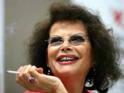 FILE PHOTO: Italian actress Claudia Cardinale smiles during a news conference in Cluj Napoca June 7, 2009. Cardinale received a lifetime award at the end of the eighth edition of the Transylvania International Film Festival (TIFF). REUTERS/Mircea Rosca (ROMANIA ENTERTAINMENT HEADSHOT)/File Photo