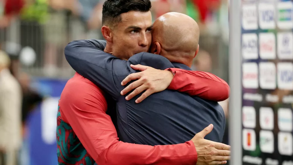 Soccer Football - FIFA World Cup 2026 - Group K - Portugal v Uzbekistan - Houston Stadium, Houston, Texas, U.S. - June 23, 2026 Portugal's Cristiano Ronaldo and coach Roberto Martinez celebrate after the match REUTERS/Phil Noble