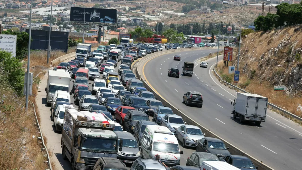 Cars queue, as displaced people make their way back to their homes in southern Lebanon following an interim deal between the U.S. and Iran, in Sidon, Lebanon, June 23, 2026. REUTERS/Aziz Taher