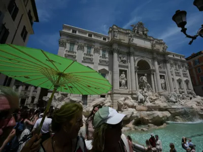 People shelter from the sun as temperatures reach record highs, in Rome, Wednesday, June 24, 2026. (AP Photo/Andrew Medichini)
