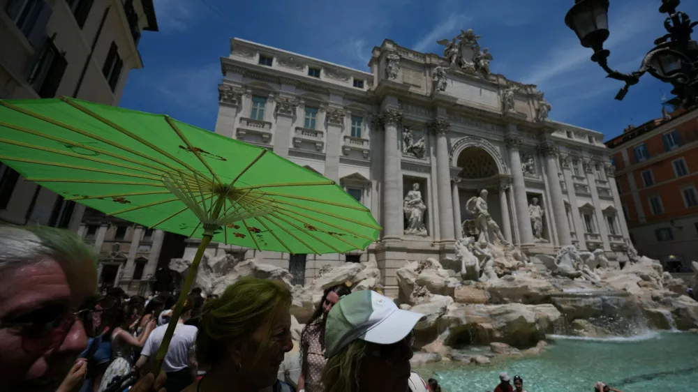 People shelter from the sun as temperatures reach record highs, in Rome, Wednesday, June 24, 2026. (AP Photo/Andrew Medichini)