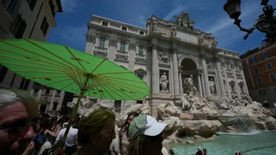People shelter from the sun as temperatures reach record highs, in Rome, Wednesday, June 24, 2026. (AP Photo/Andrew Medichini)