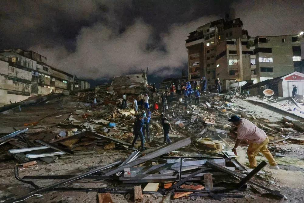 Rescue workers search through the rubble after an earthquake in Caracas, Venezuela, Wednesday, June 24, 2026. (AP Photo/Javier Campos)