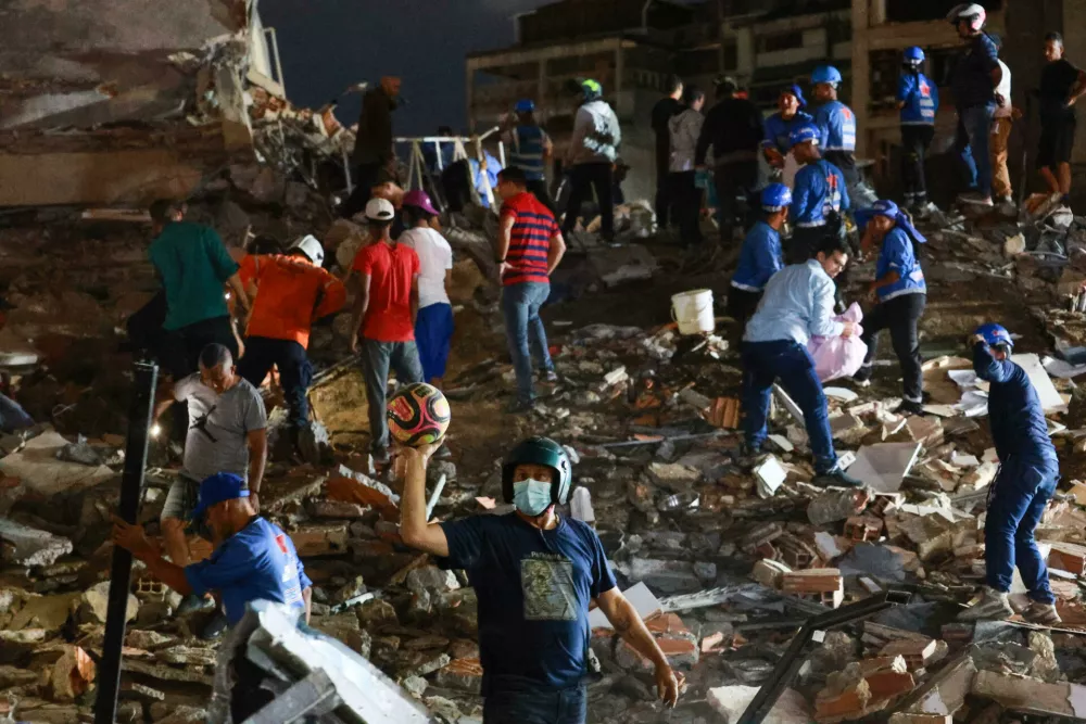 Rescue workers search through the rubble after an earthquake in Caracas, Venezuela, Wednesday, June 24, 2026. (AP Photo/Javier Campos)